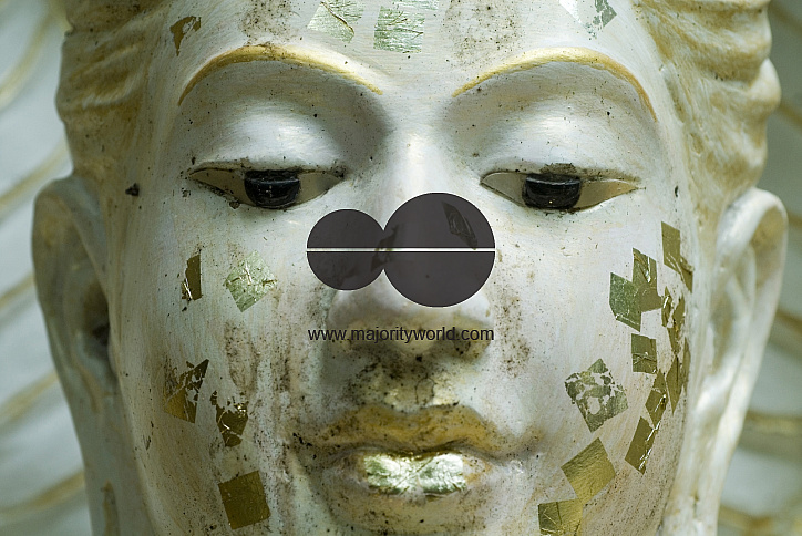Thailand. Face of statue at a Buddhist temple.