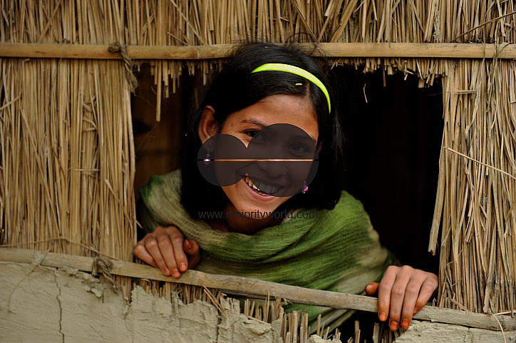  A girl looks out of the window of her house