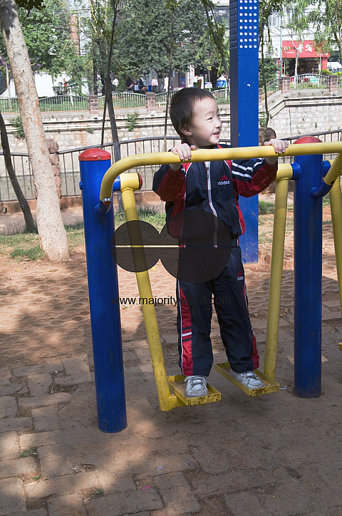 CHINA Boy exercising in a park in Kunming, Yunnan province..