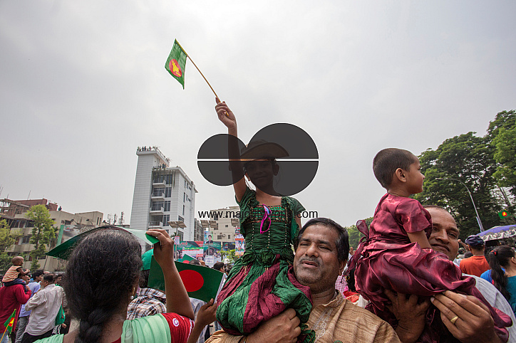 A man carrying a child on his shoulder. Bangladesh