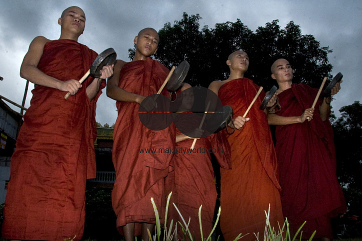 Buddhists celebrating Prabarana Purnima with lighing lamps