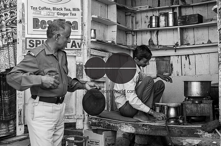  A security guard buying from a chai stall in the golden fort, Jaisalmer.