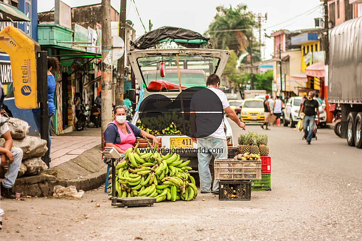 A couple sells bananas at the local street market