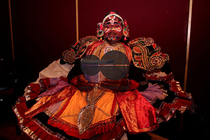 A South Indian dancer read a book before a stage show at a dance festival in Kolkata