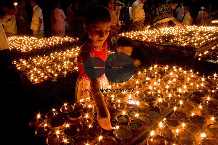 Buddhists celebrating Prabarana Purnima with lighing lamps