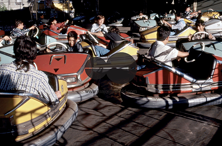 URUGUAY YOUTH PLAYING WITH SCOOTER CARS AT AN AMUSEMENT PARK. Photo ¬© Julio Etchart