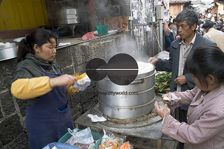 CHINA Vendors selling dumplings at the market place in a village in Yunnan province.
