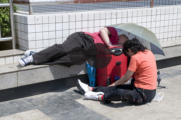 CHINA Migrant workers from the countryside waiting outside Guangzhou train station, Guangdong province.
