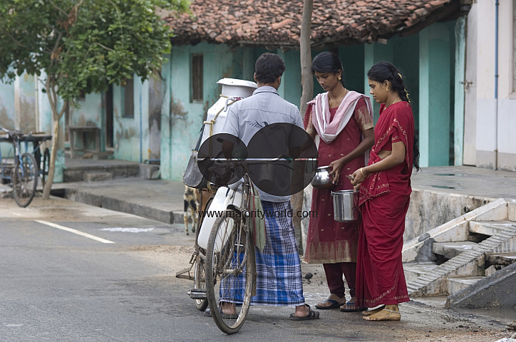 India. Women buying fresh milk in the morning.