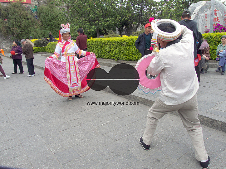 CHINA Chinese tourists photographing Ethnic Bei women dressed in traditional costume in Dali, Yunnan province.