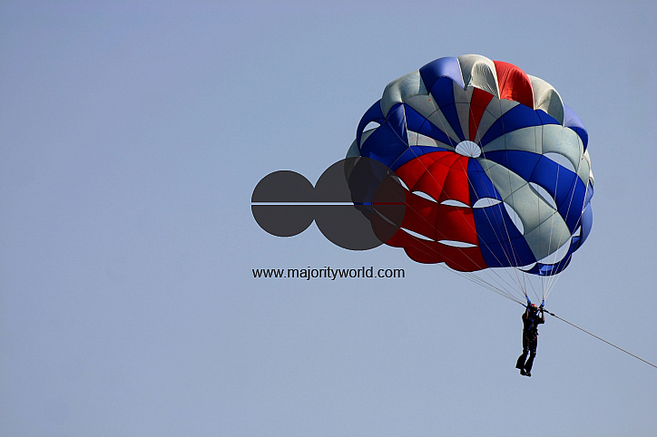 An Indian NCC trainee flies with Para suit on the eve of NCC day in Kolkata