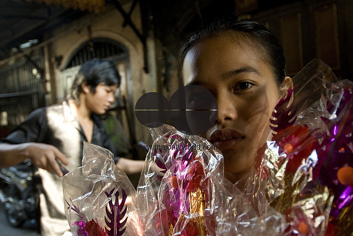 Thailnd. Girl selling flowers in Chinatown, Bangkok.