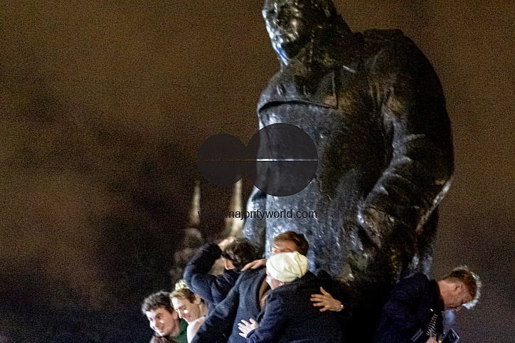 Group of Men celebrating Brexit Night on the Churchill Statue