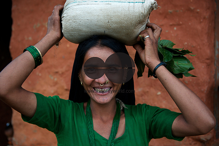  Jamuna Saud, carrying a bag of rice and some green leafy vegetables,