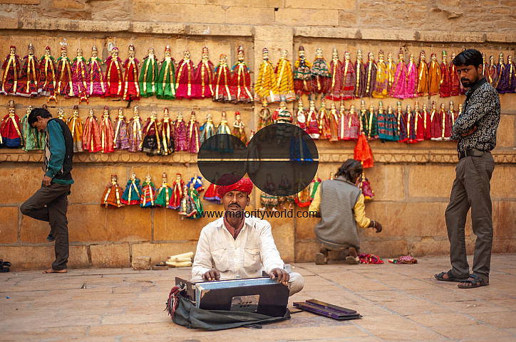  A Rajasthani musician singing and playing the Tanpura in a market area in Jaisalmer.