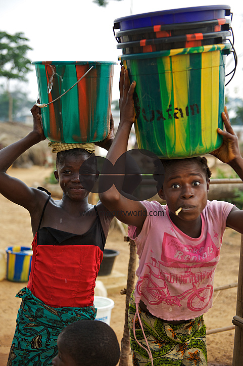  Liberian girls carrying empty buckets
