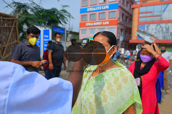The health workers are applying infrared thermometer to check the temperatures
