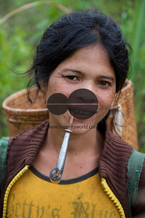  A woman smoking a traditional pipe
