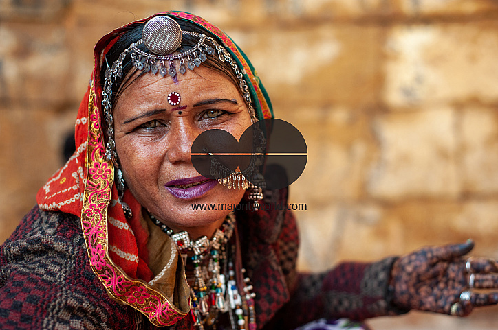  A street vendor in Jaisalmer asking passers-by to purchase the jewellery she is selling.