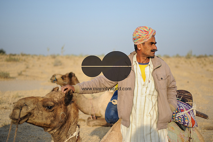  A camel herder with his camel.