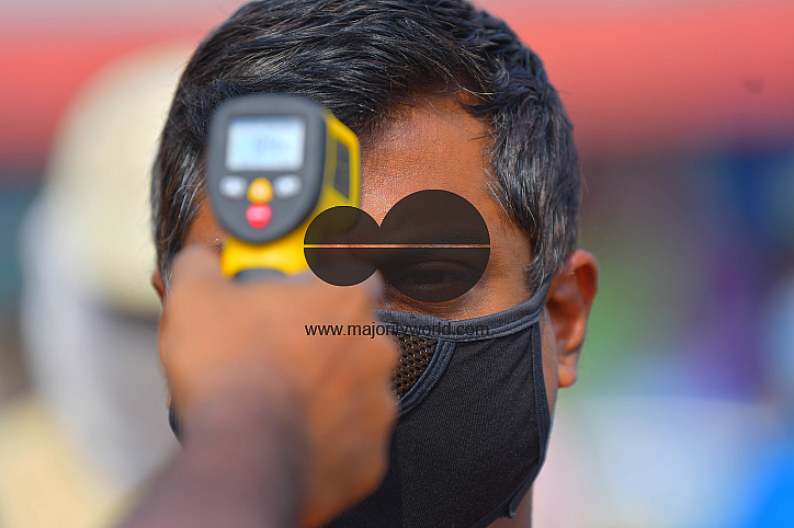 The health workers are applying infrared thermometer to check the temperatures