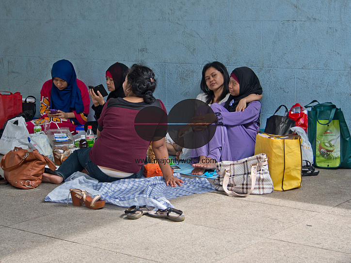 Migrant domestic workers enjoy a day off by the Bay side in Singapore