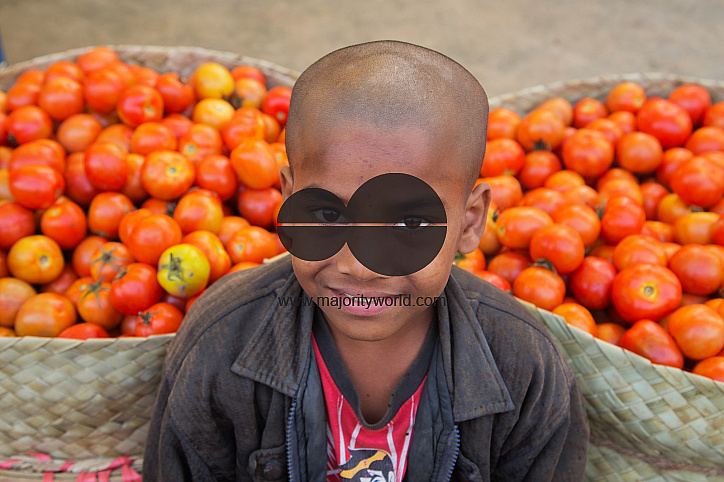 Portrait of a young boy, selling tomatos in Dhaka, Bangladesh.