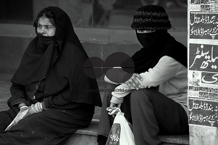  Two women sitting near the market area, Lahore.