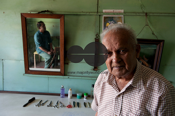 Mauritius. Mr. Gopaul, barber, in his salon. Mahebourg.