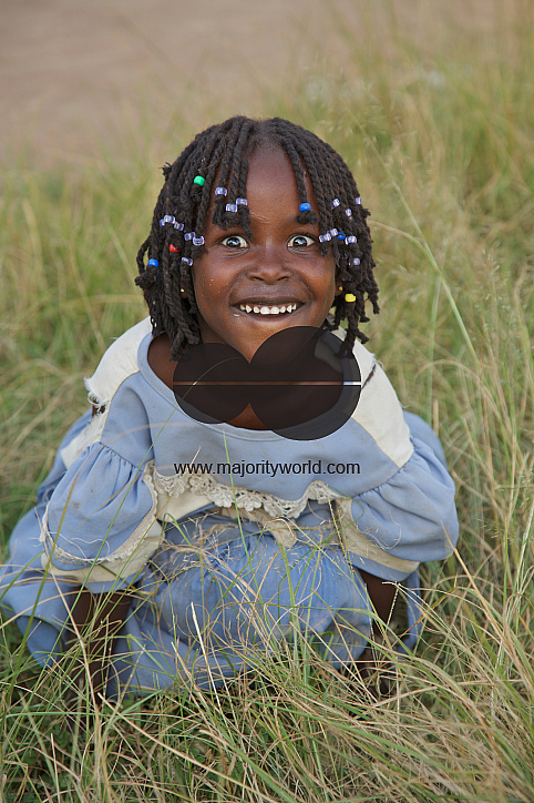  A girl child makes fun and smiles