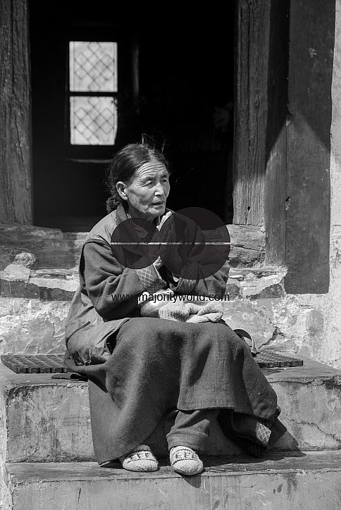 A woman praying outside in the Thiksey Monastery, Ladakh.