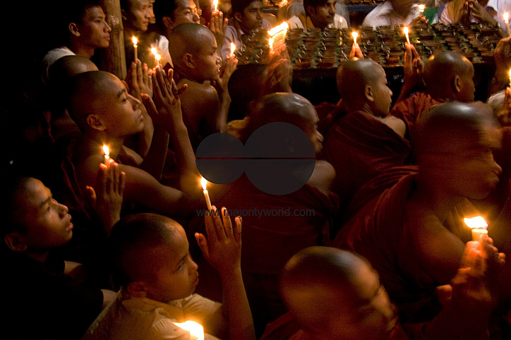 Buddhists celebrating Prabarana Purnima with lighing lamps