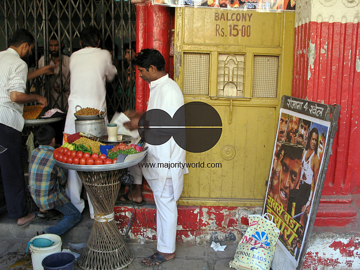 INDIA.People buying snacks during an interval in an old picture house in Mumbai.
