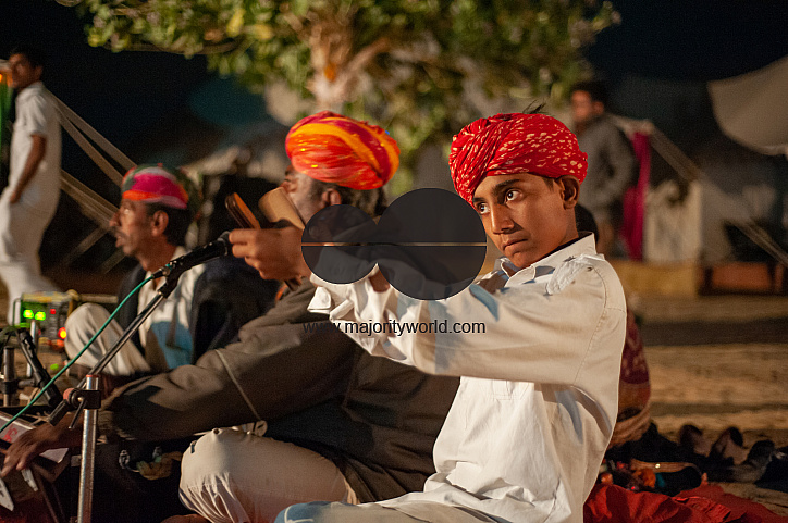  Musicians performing traditional Rajasthani music for tourists who camp in the desert.