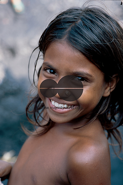  A young girl child smiles in Ayena Ghat