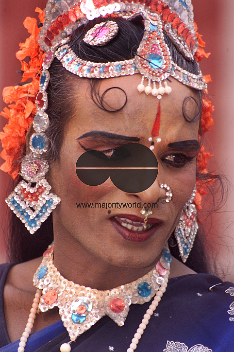 A South Indian male dancer dressed like a woman smiles during a stage show at a dance festival in Kolkata, India