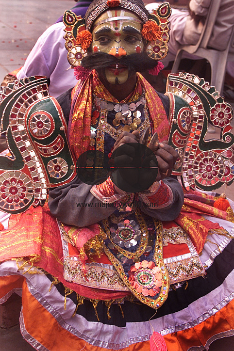 A South Indian dancer plays an instrument during a stage show at a dance festival in Kolkata