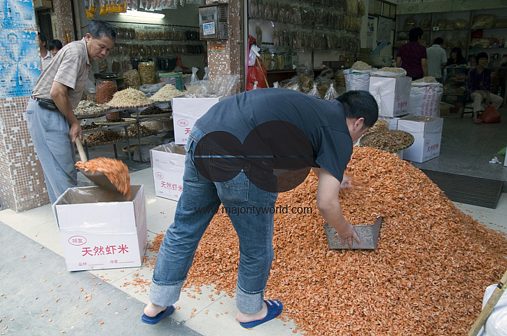 CHINA Merchants packing dry shrimps, a local delicacy, in the old quarter in Guangzhou, Guangdong province..