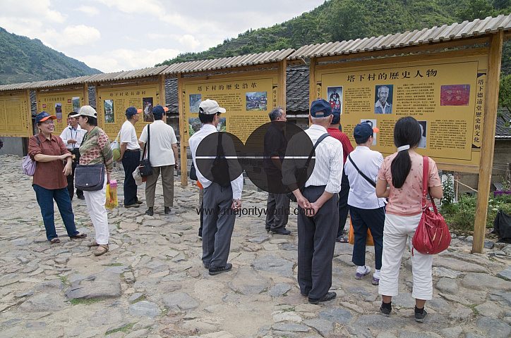 CHINA Chinese tourists visiting the ancestors temple and memorial wall in a traditional Hakka village in Fujian province.