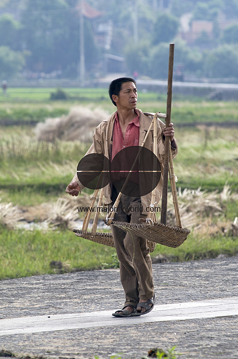 CHINA Peasant with farming tools in Yunnan province.
