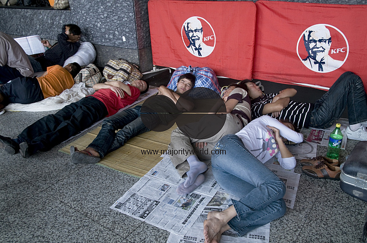 CHINA Migrant workers from the countryside waiting outside Guangzhou train station, Guangdong province.