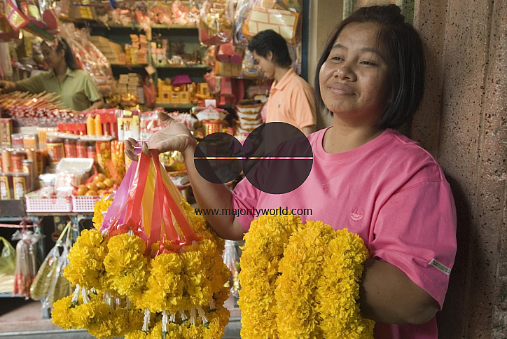 Thailand. Flower seller at temple in Chinatown. Bangkok.