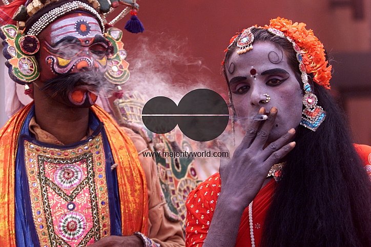 A South Indian dancer smokes cigarette during a short brake of stage show at a dance festival in Kolkata, India
