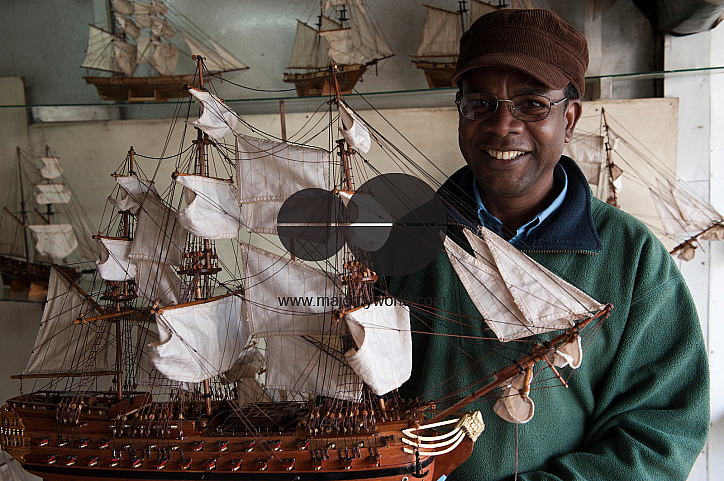 Mauritius. Harel Celestin holds one of the model boats he makes.