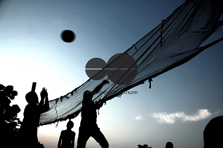 Children play volleyball at Deeper Life Camp Ground, a non-governmental camp for displaced persons a