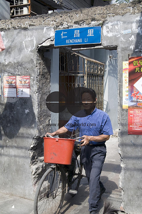 CHINA Elderly man with bycicle in the old quarter in Guangzhou, Guangdong province..