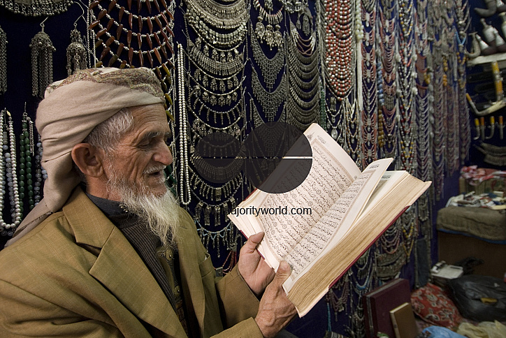 Yemen. Man reading his Koran in his shop. Old City. San'a'.