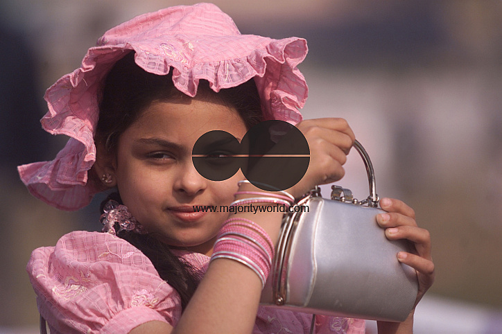 An Indian girl poses during vintage car rally in Kolkata