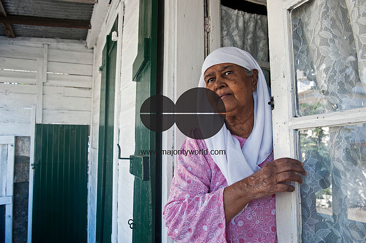 Mauritius. A lady at the front door to her fine Creole home in Mahebourg.