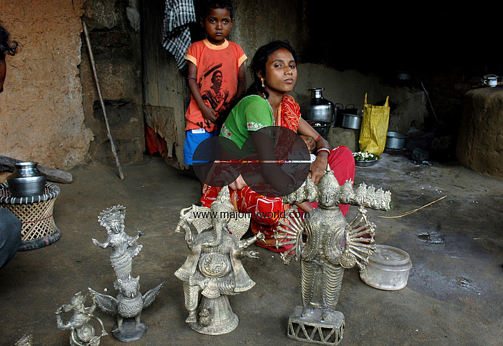 A family that makes bronze idols for a living. Bankura, West Bengal, India. July 14, 2005. .
